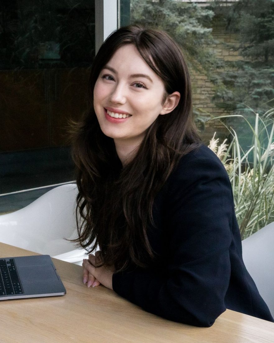 Charlotte Kaufmann at a table with her laptop